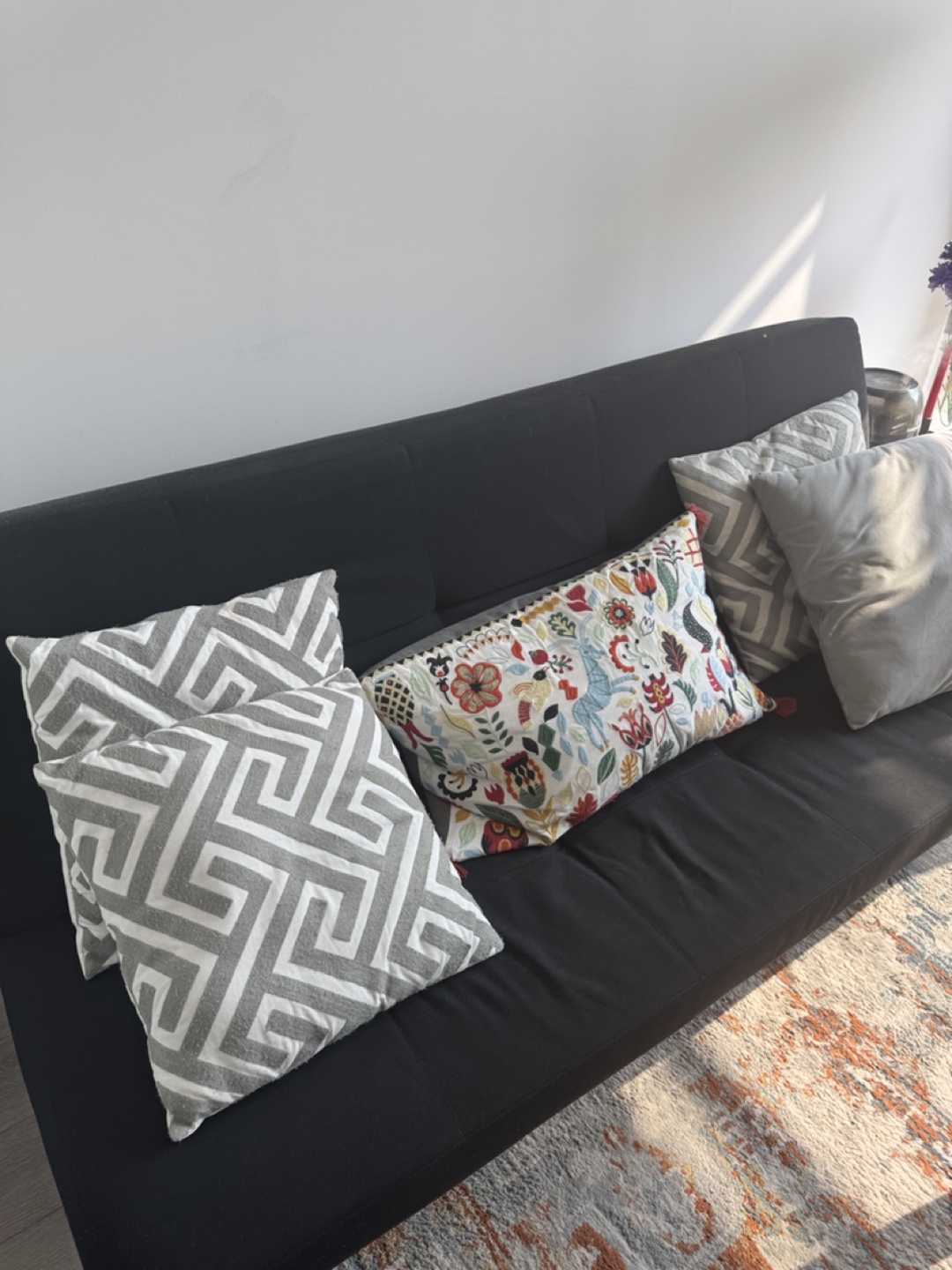Black sofa bed with 4 cushions
