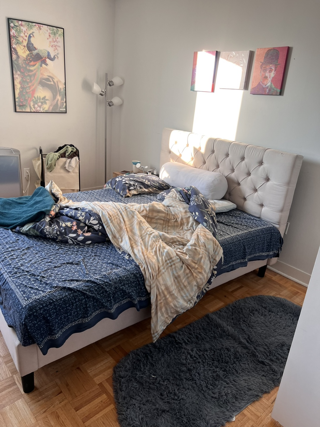 Queen-sized bed frame with tufted headboard