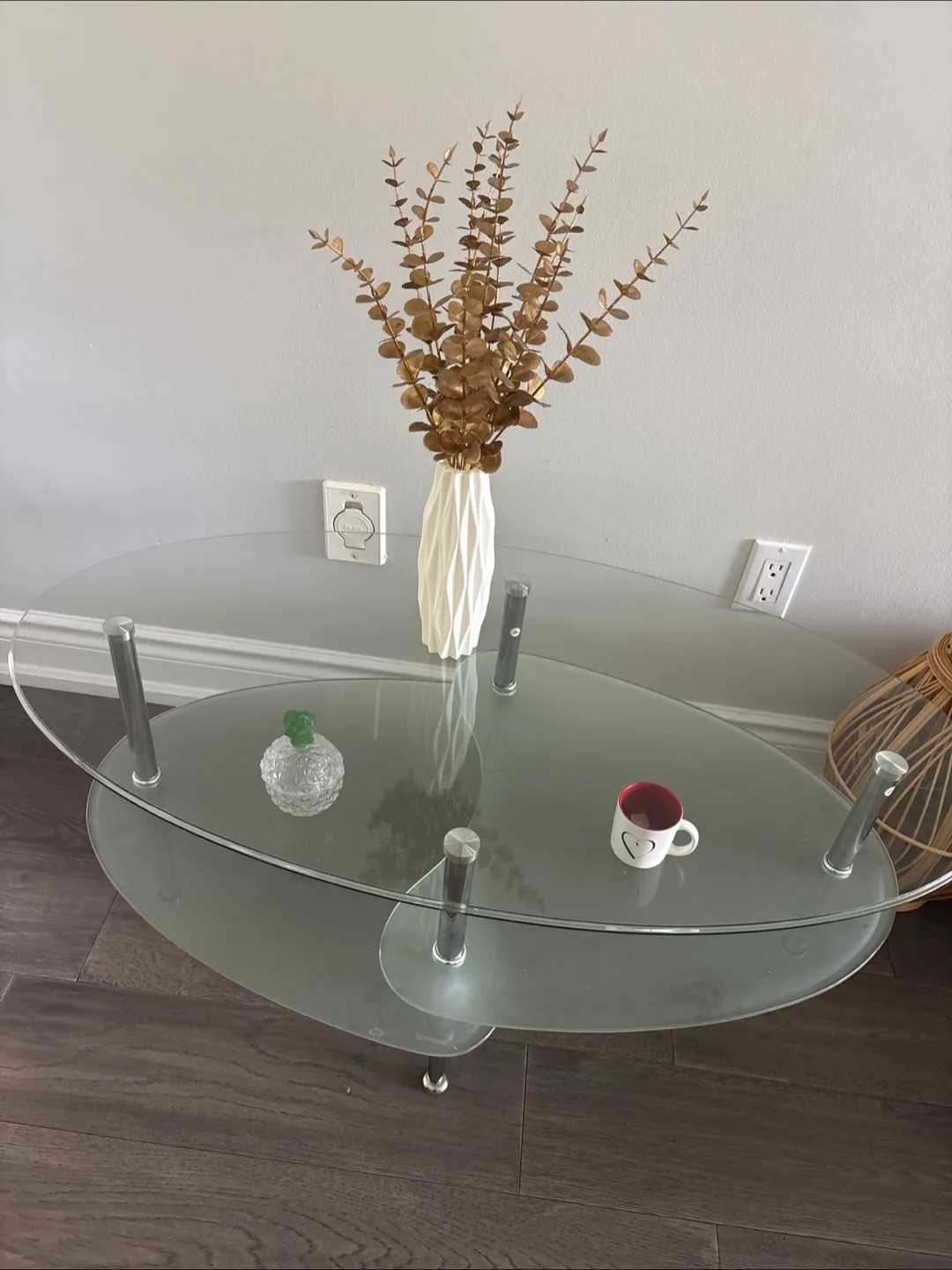 Glass coffee table with decorative flowers and vase thumbnail