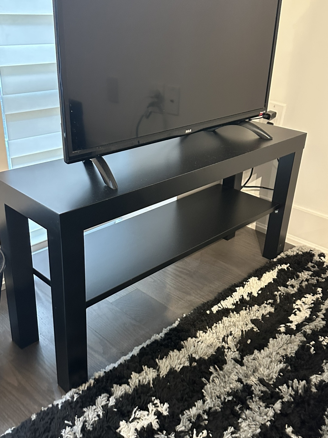 Black TV stand with shelf