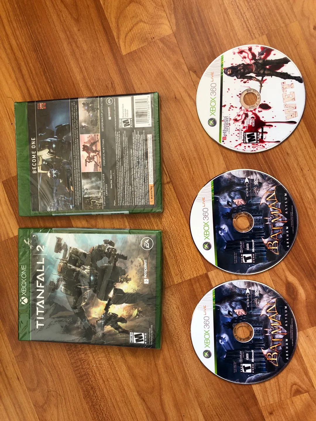 Xbox one: Titanfall 2 (sealed); xbox 360: Wet; Batman Arkham image indicator(2)