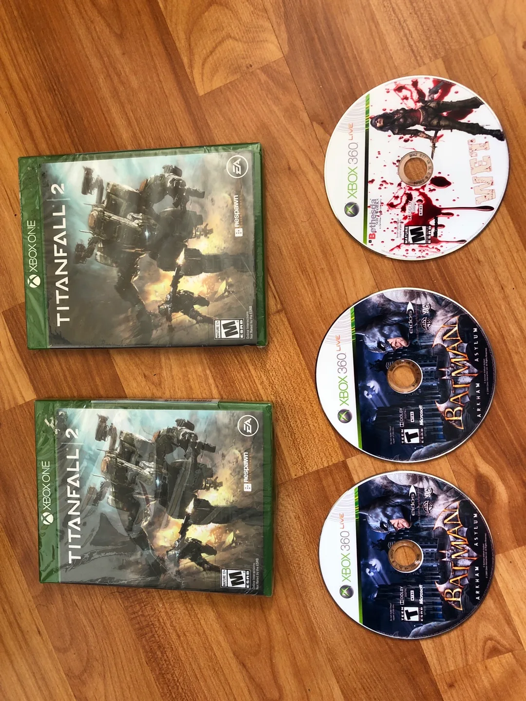 Xbox one: Titanfall 2 (sealed); xbox 360: Wet; Batman Arkham image indicator(3)