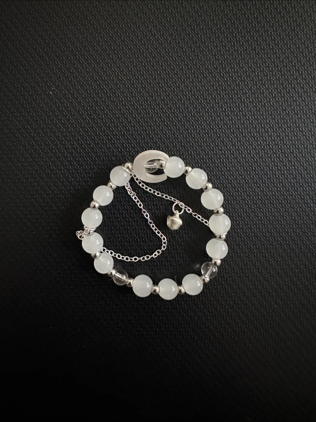 White beaded bracelet with charm image indicator(2)