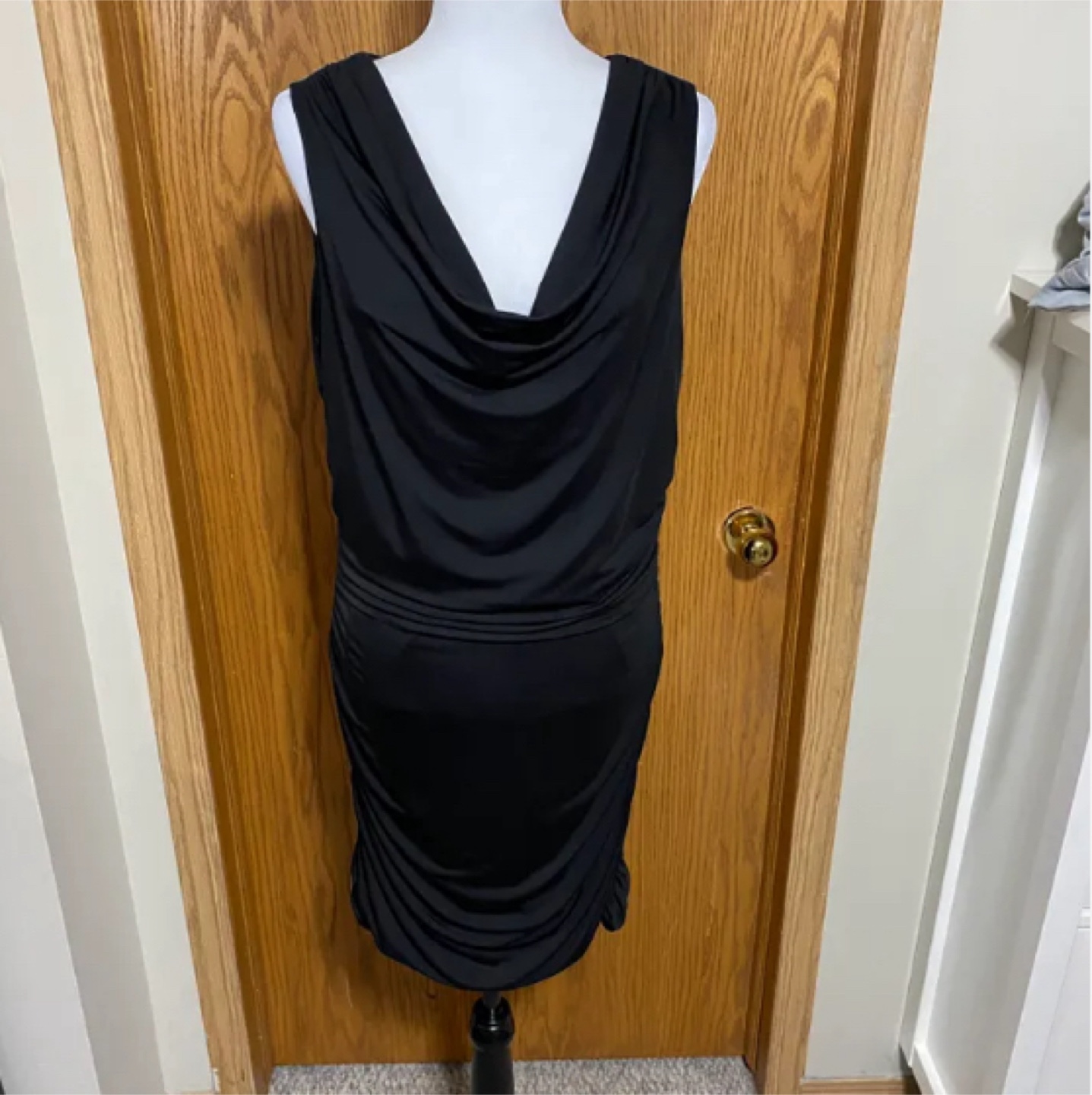 Black bodycon dress with drape neckline and ruching on sides