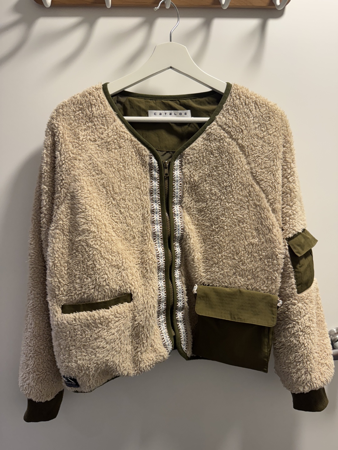 Cozy beige sherpa jacket with olive accents