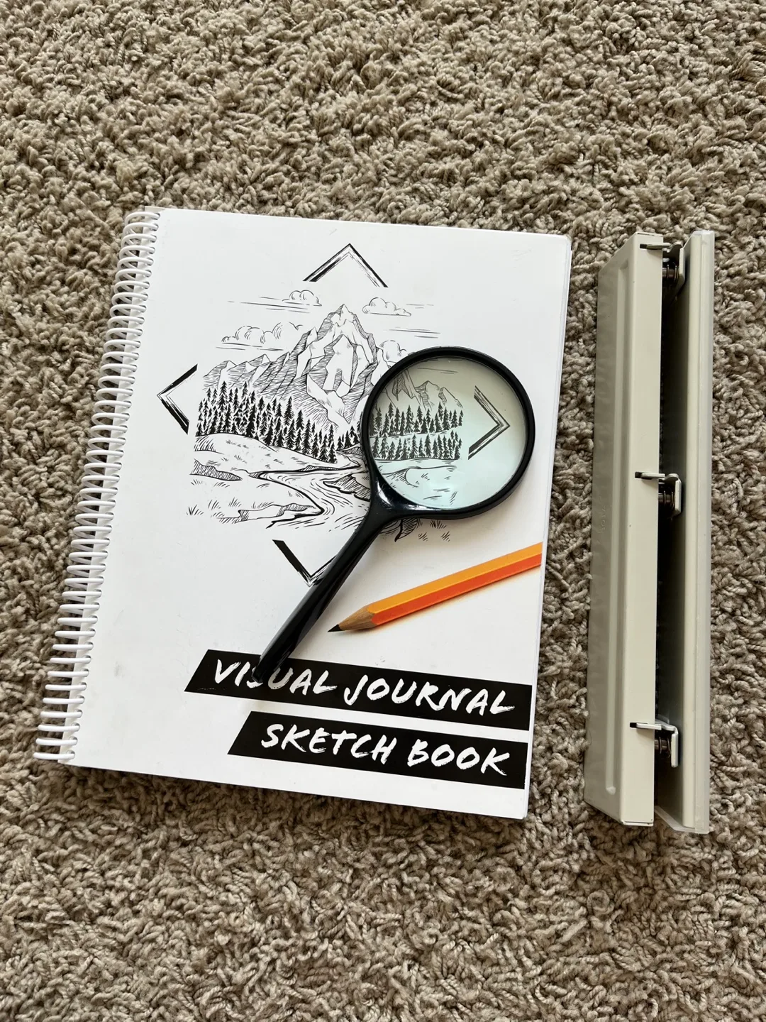 Sketchbook, Magnifying Glass, and Hole Punch