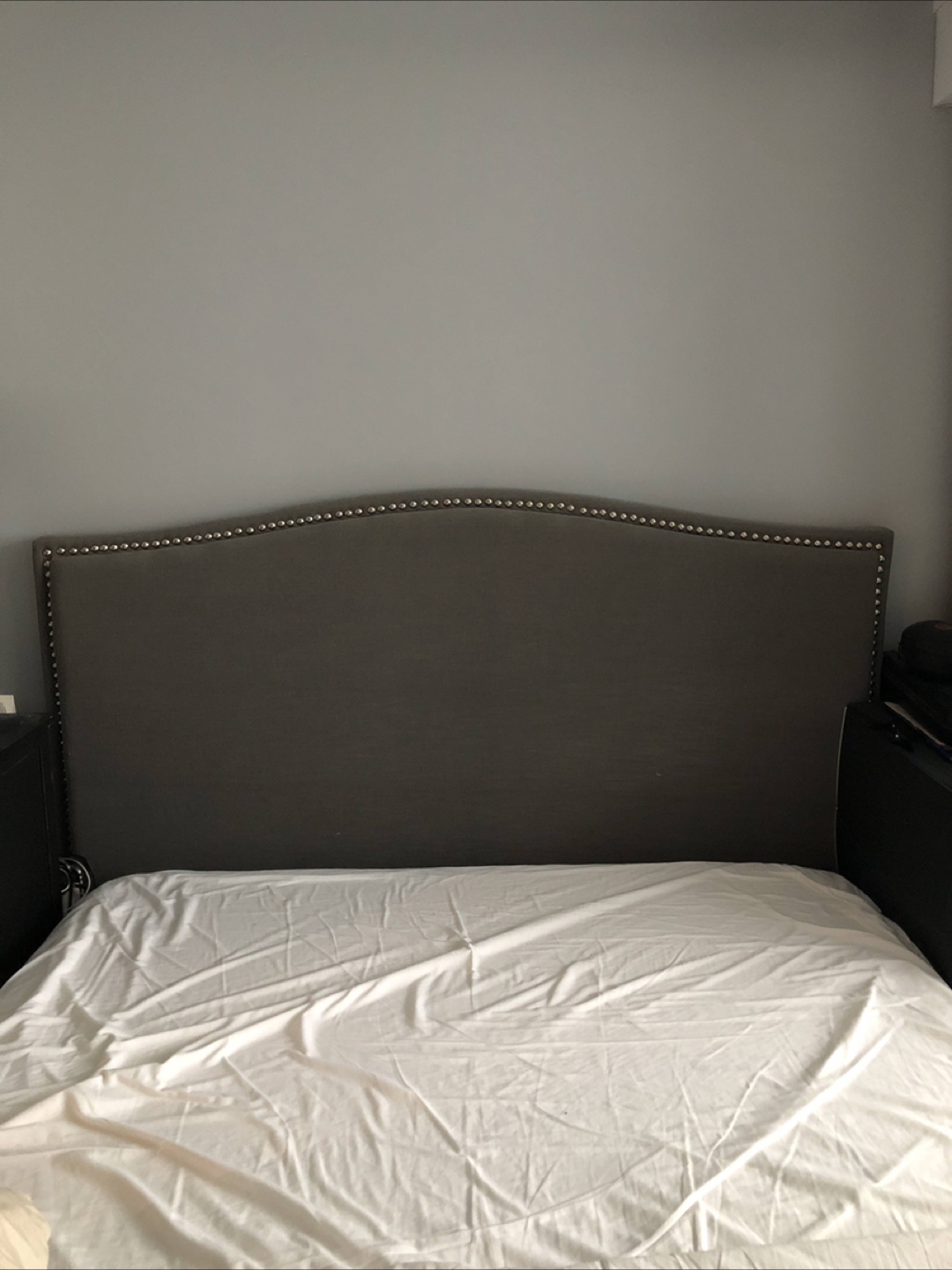 Grey Fabric Headboard with Nailhead Trim