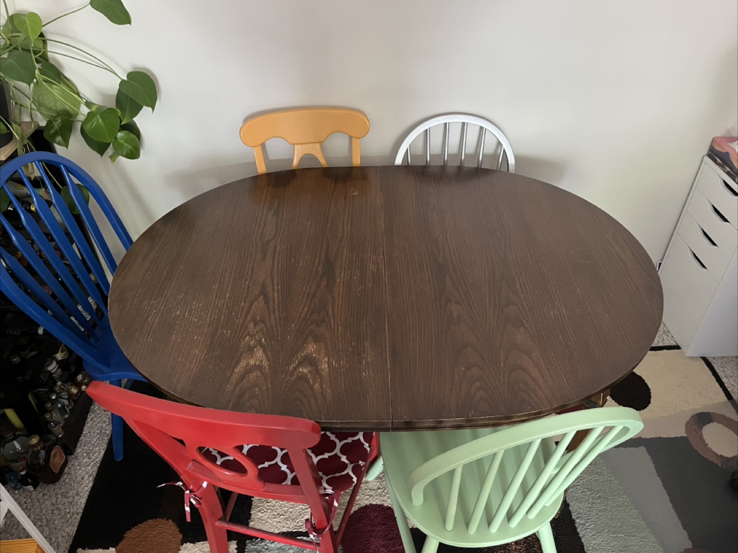 Dark Wood Oval Extendable Dining Table with Painted Wood Chairs