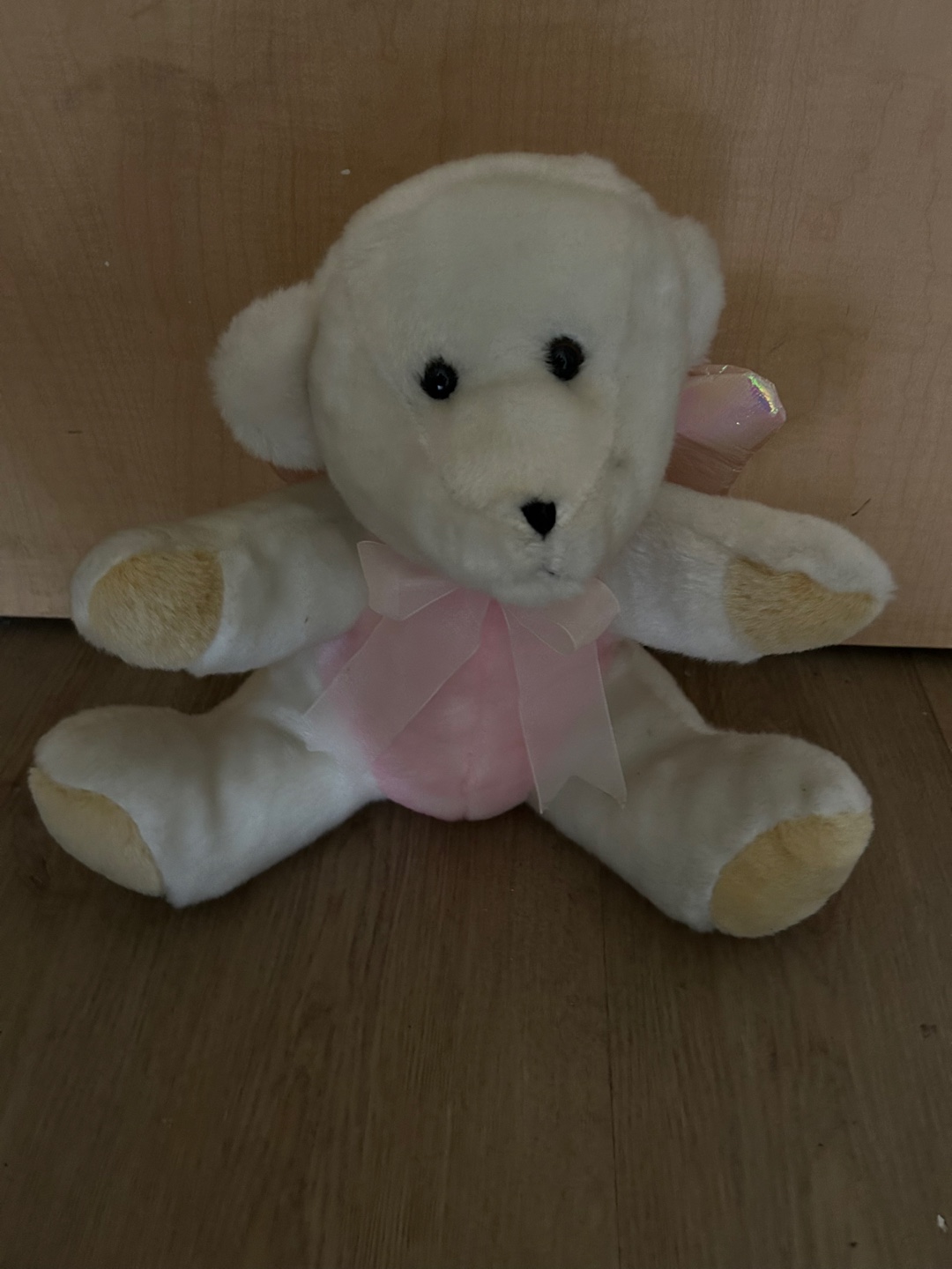Cute white teddy bear with pink ribbon