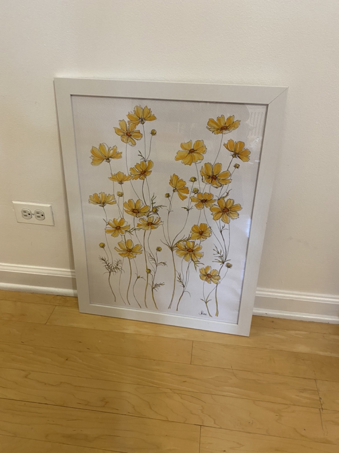 Two white poster frames with prints