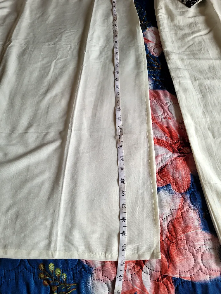 White two-piece outfit with black detailing image indicator(2)