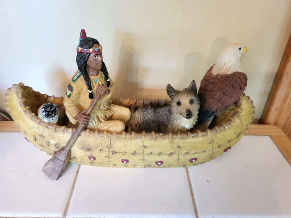 Figurine of Native American in Canoe with Animals thumbnail