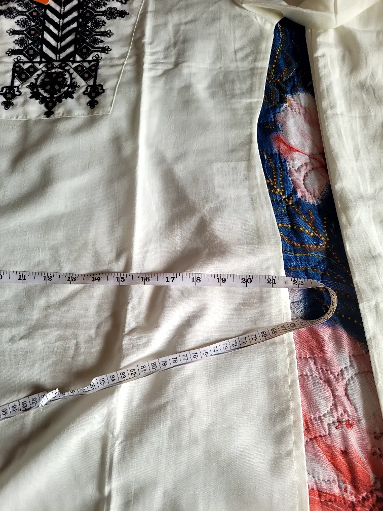 White two-piece outfit with black detailing image indicator(5)