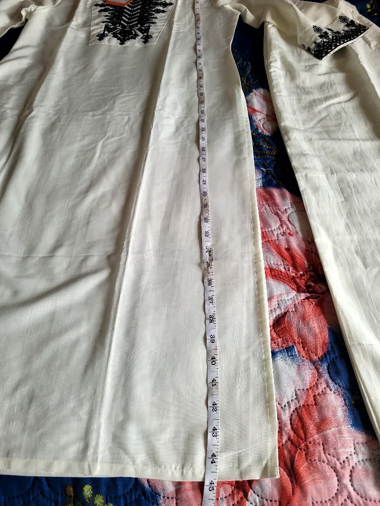 White two-piece outfit with black detailing image indicator(3)