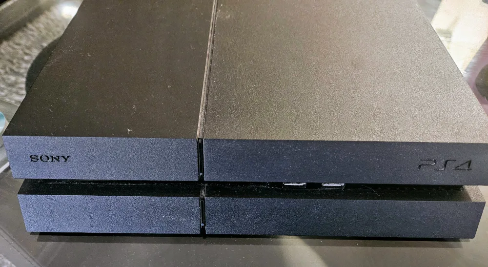 Sony PlayStation 4 (PS4) plus 2 controllers & 2 games thumbnail