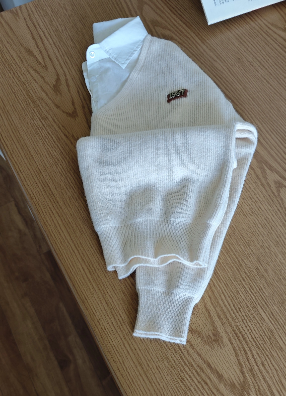 Cream-Coloured Knit Sweater and White Blouse