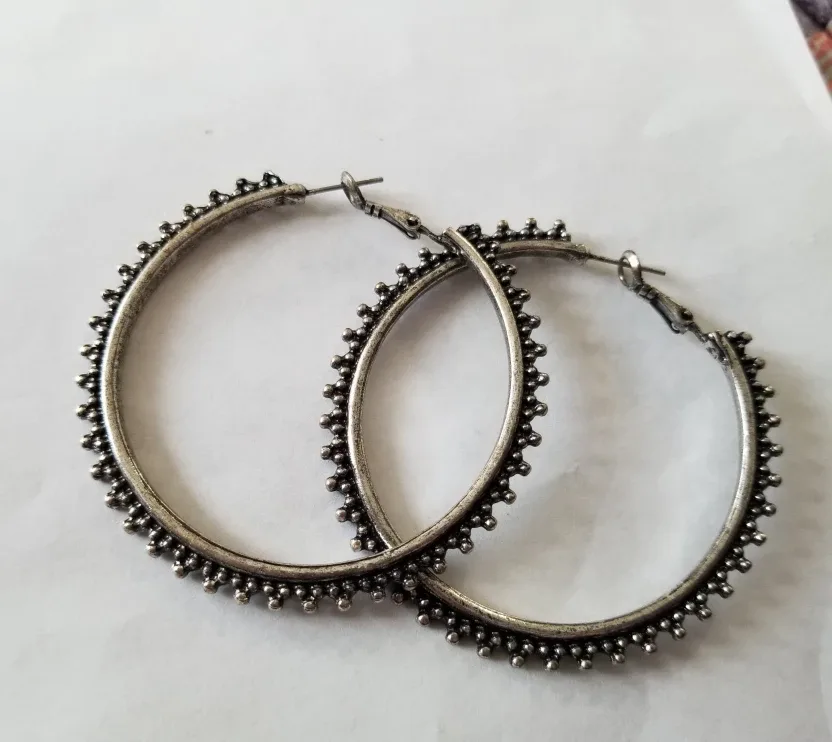 Large silver tone metal hoop earrings. thumbnail