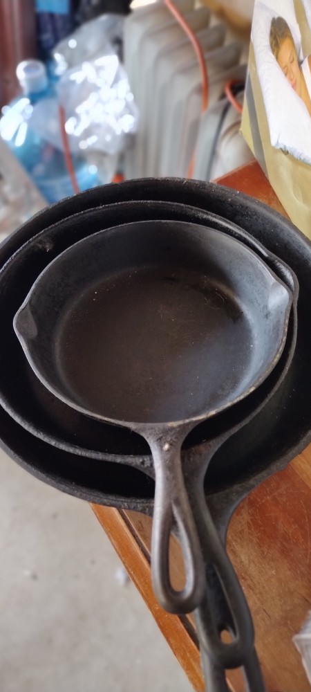 set of three cast iron pans
