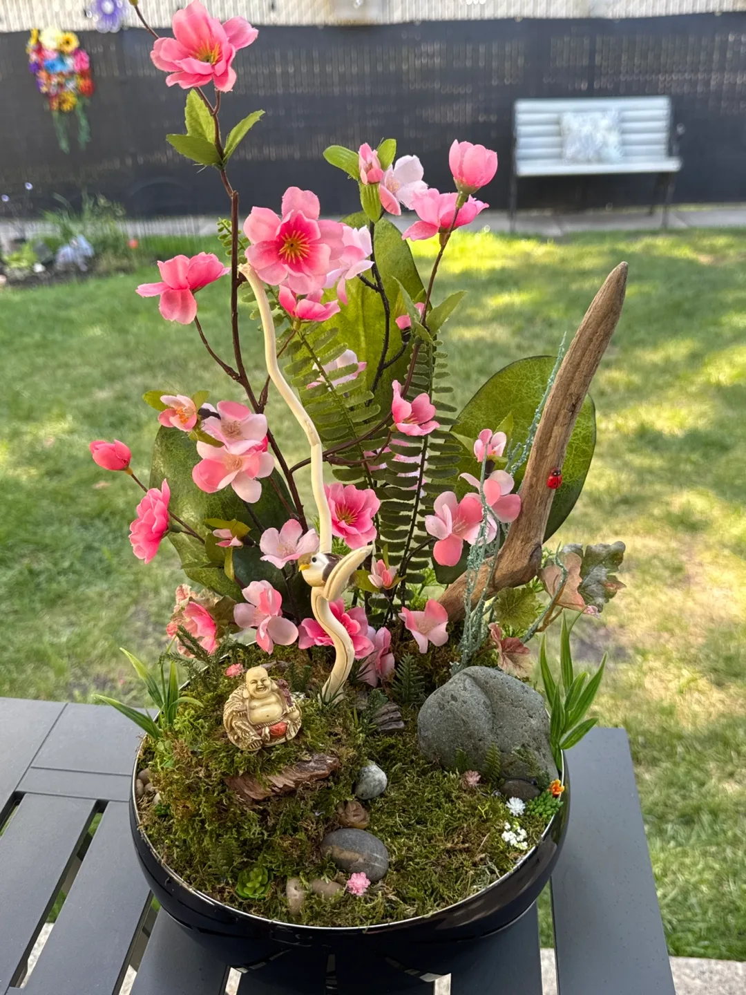 Beautiful blossoming tree garden and the happy Buddha thumbnail
