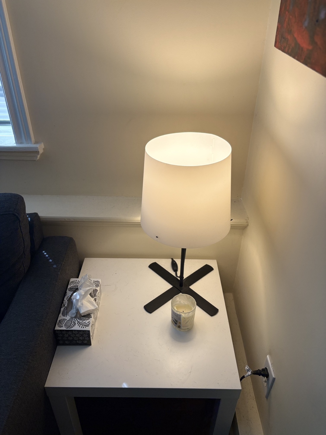 Table lamp with white shade and white side table