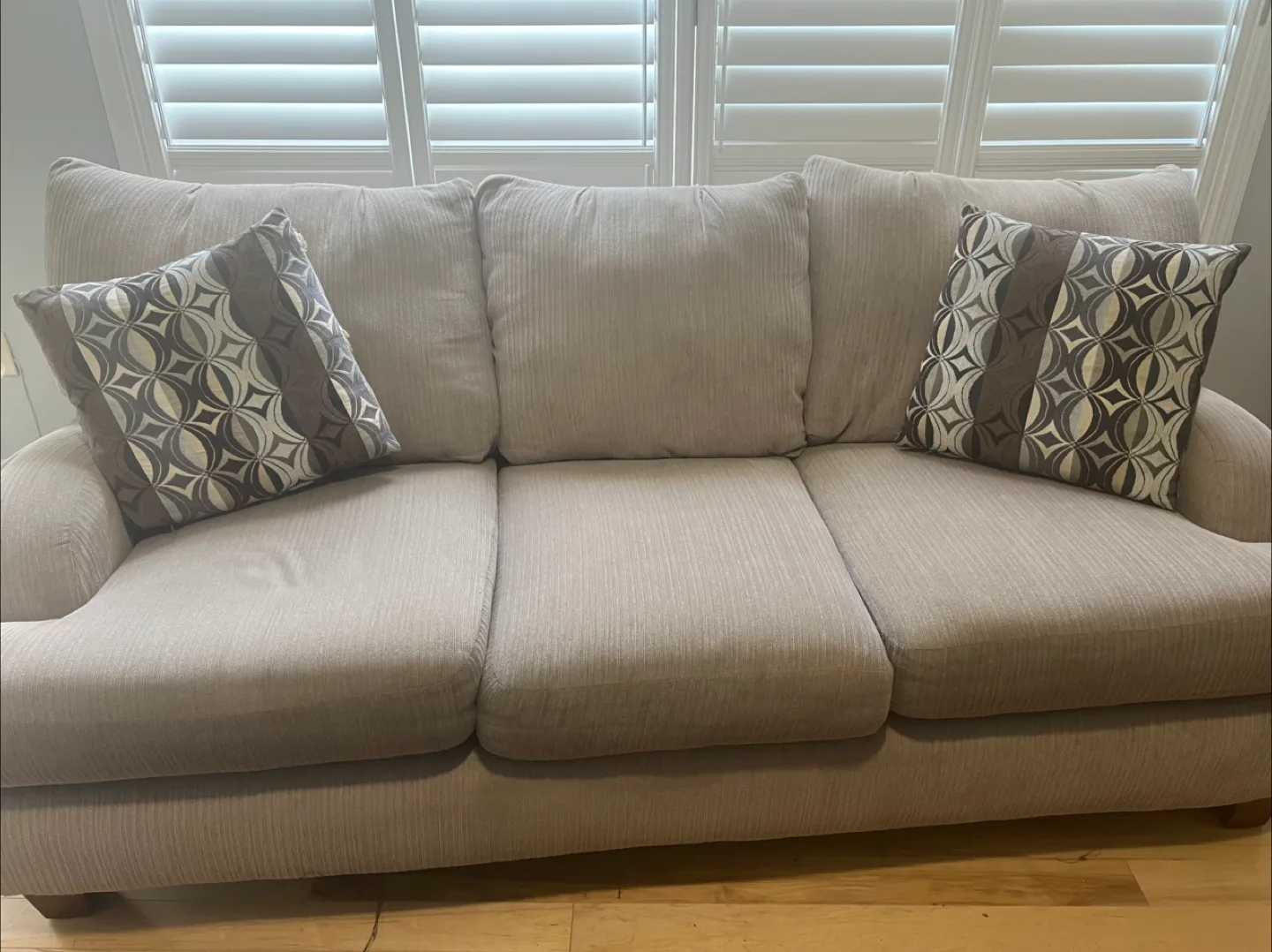 Beige Sofa with Two Decorative Pillows thumbnail