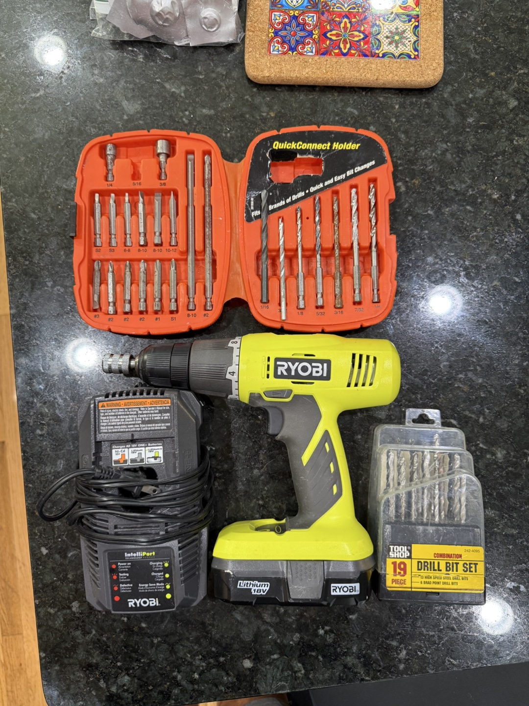 Ryobi 18V rechargeable power drill with a variety of bits