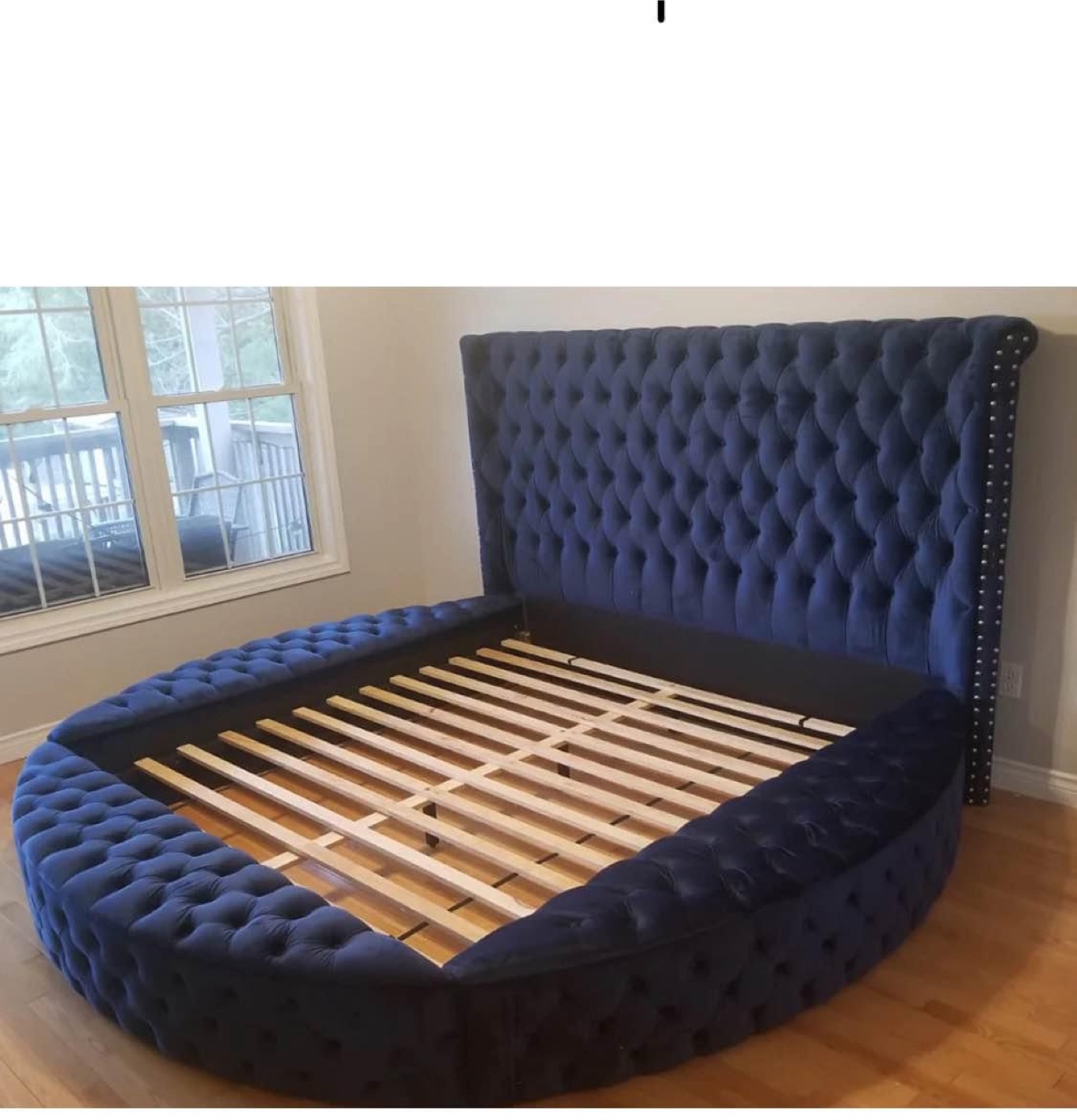 Blue tufted kind size bed