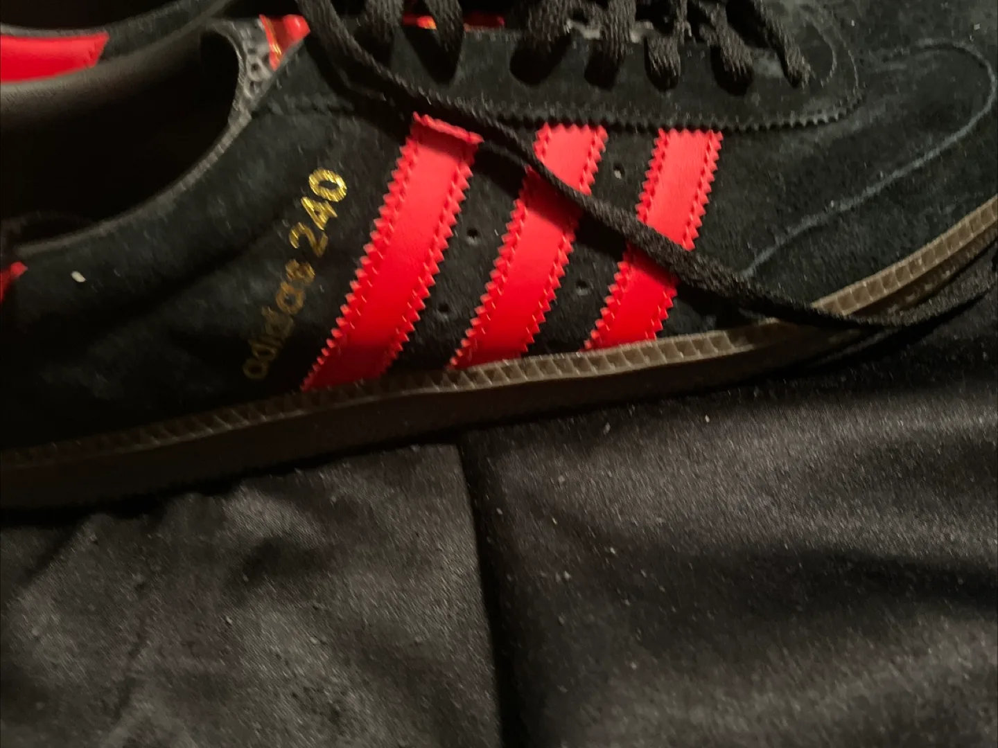 Red and black adidas shoes image indicator(2)