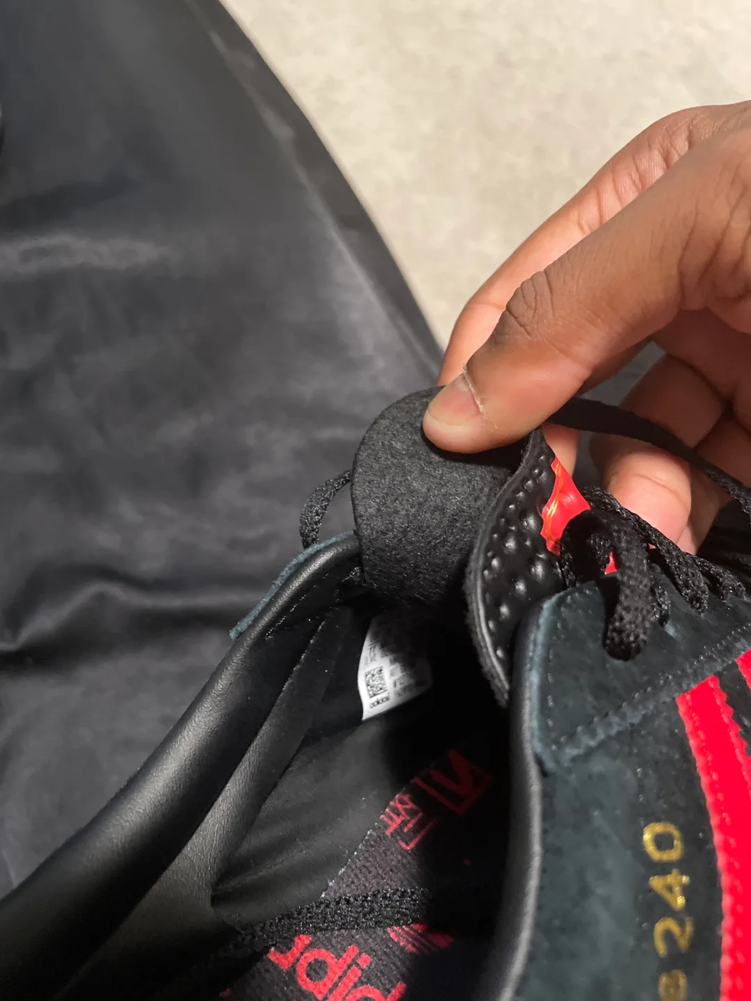 Red and black adidas shoes image indicator(4)