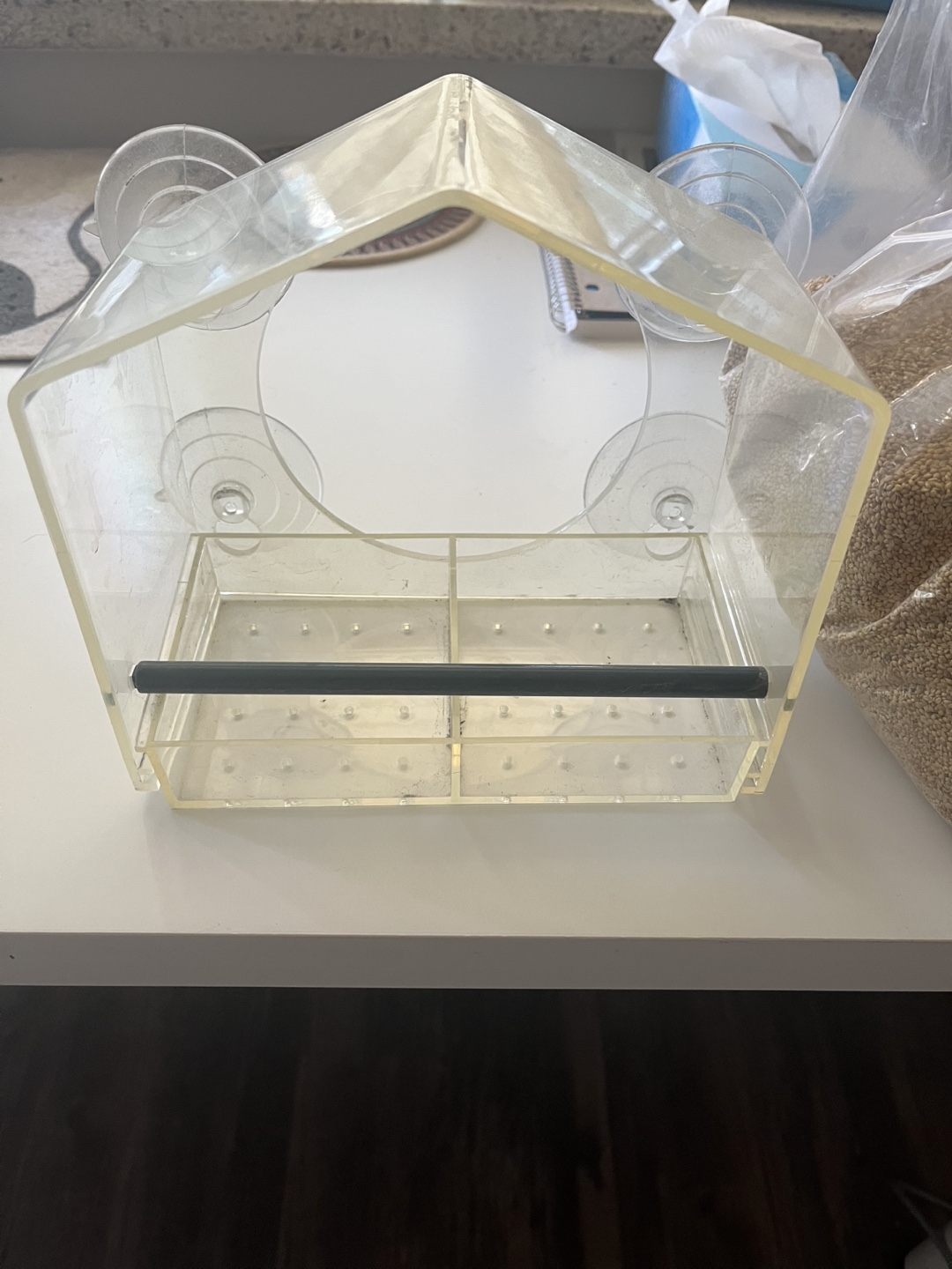 Bird feeder and a bag of seeds