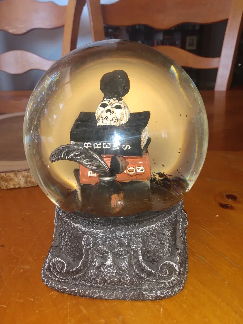 Snow Globe with Skull and Books, Gold dinosaur snow Globe thumbnail