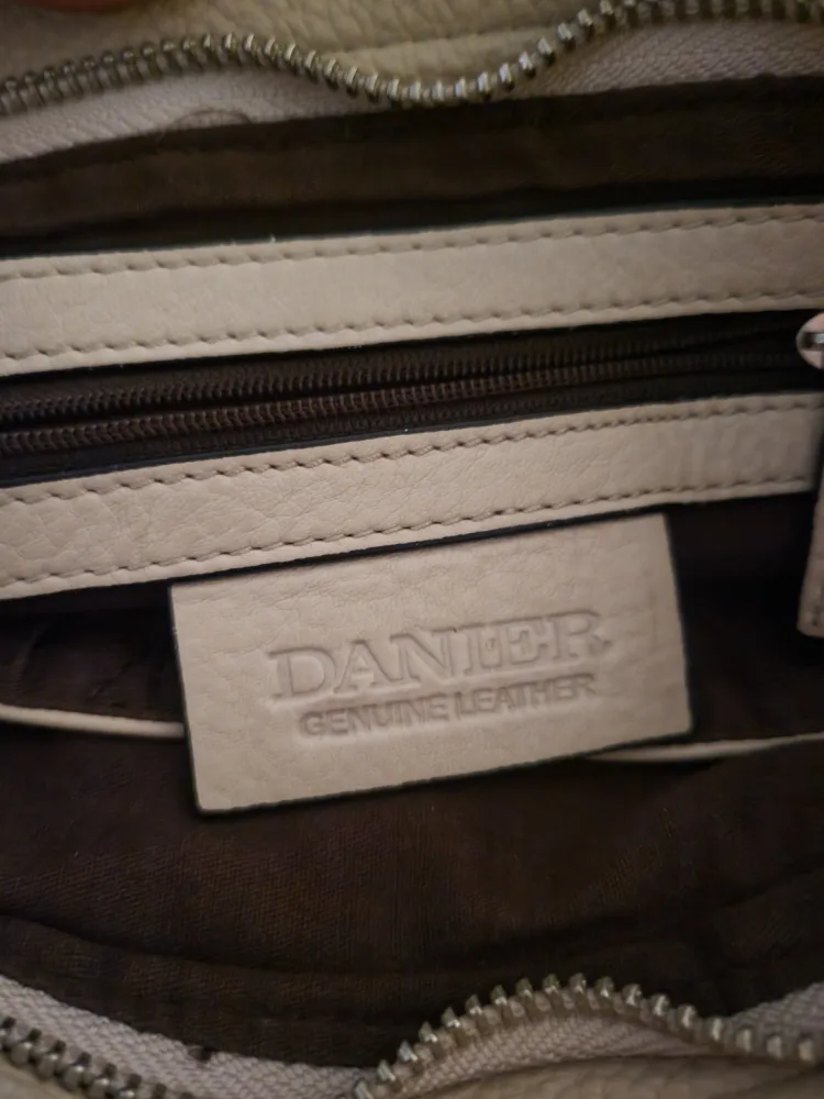 Danier tan shoulder bag with tassel.. image indicator(8)