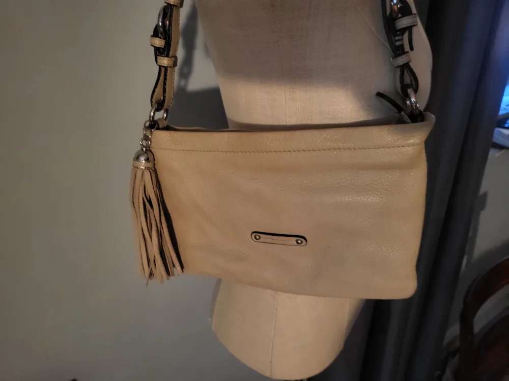 Danier tan shoulder bag with tassel.. image indicator(2)