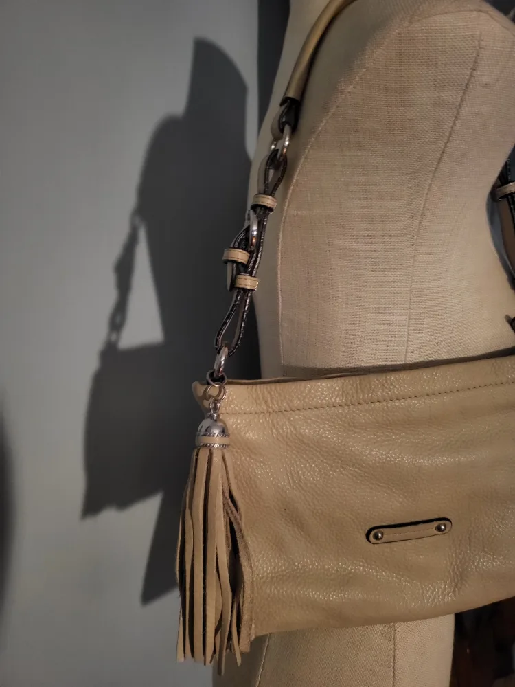 Danier tan shoulder bag with tassel.. image indicator(4)