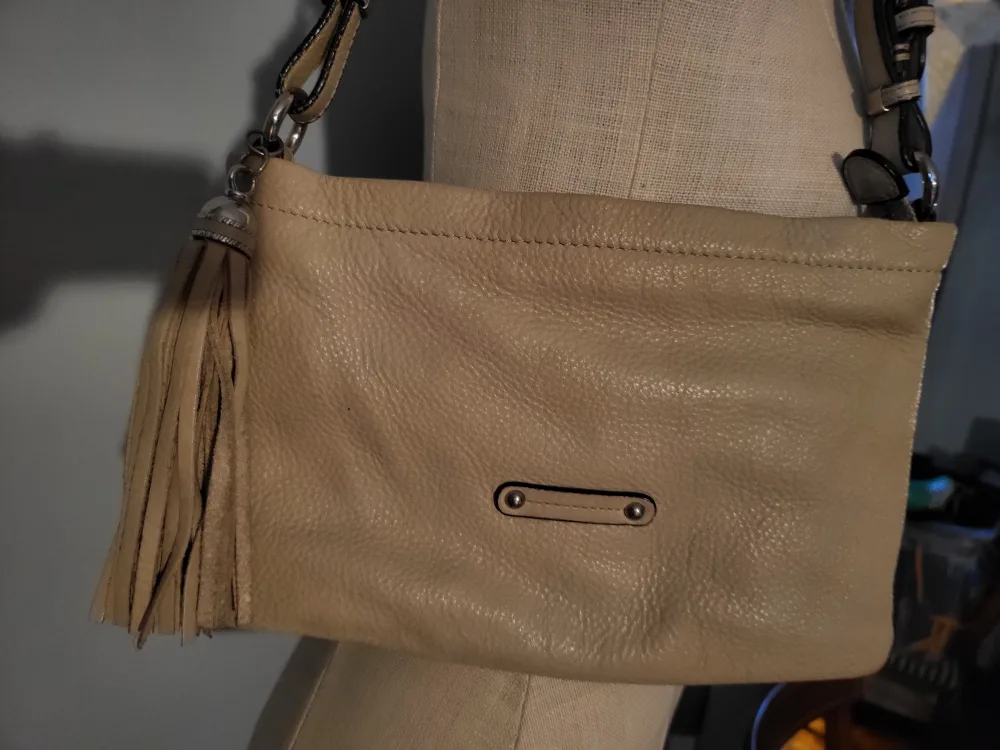 Danier tan shoulder bag with tassel.. image indicator(5)