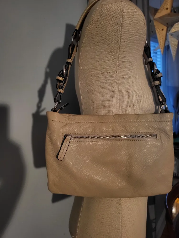 Danier tan shoulder bag with tassel.. image indicator(6)