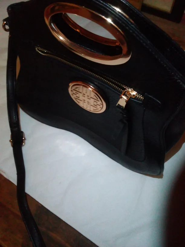 Black handbag with gold accents thumbnail