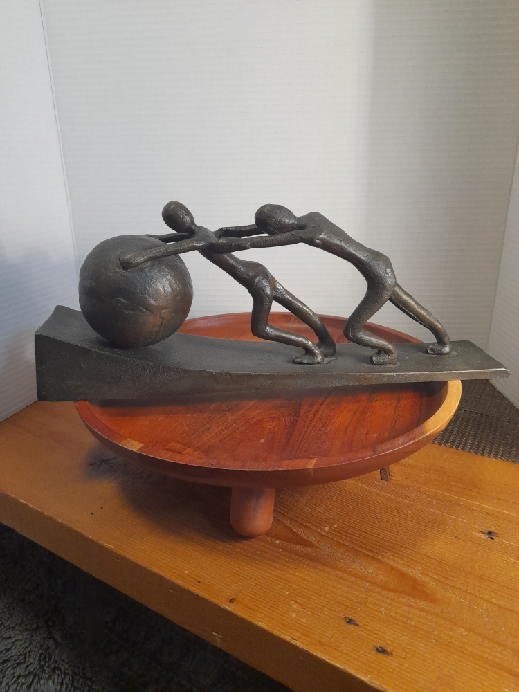 Figurine of People Pushing a Ball
