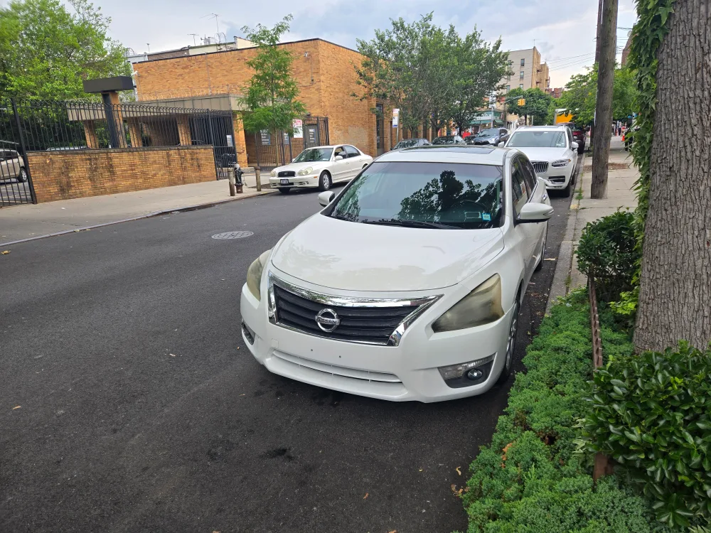 Nissan Altima - White Sedan thumbnail