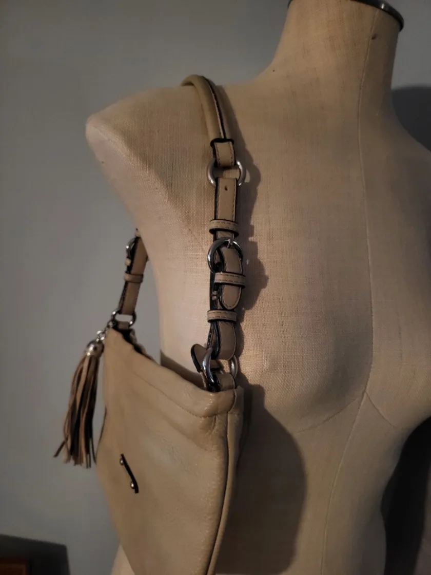 Danier tan shoulder bag with tassel.. image indicator(3)