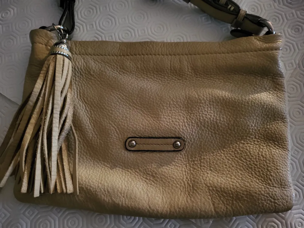 Danier tan shoulder bag with tassel.. image indicator(9)