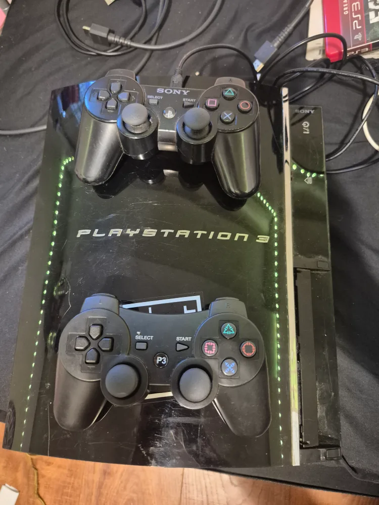 PS3 Console with 2 controllers and games thumbnail