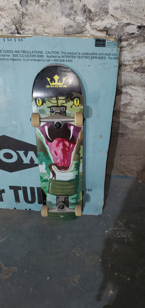Crown Skateboard with Snake Design