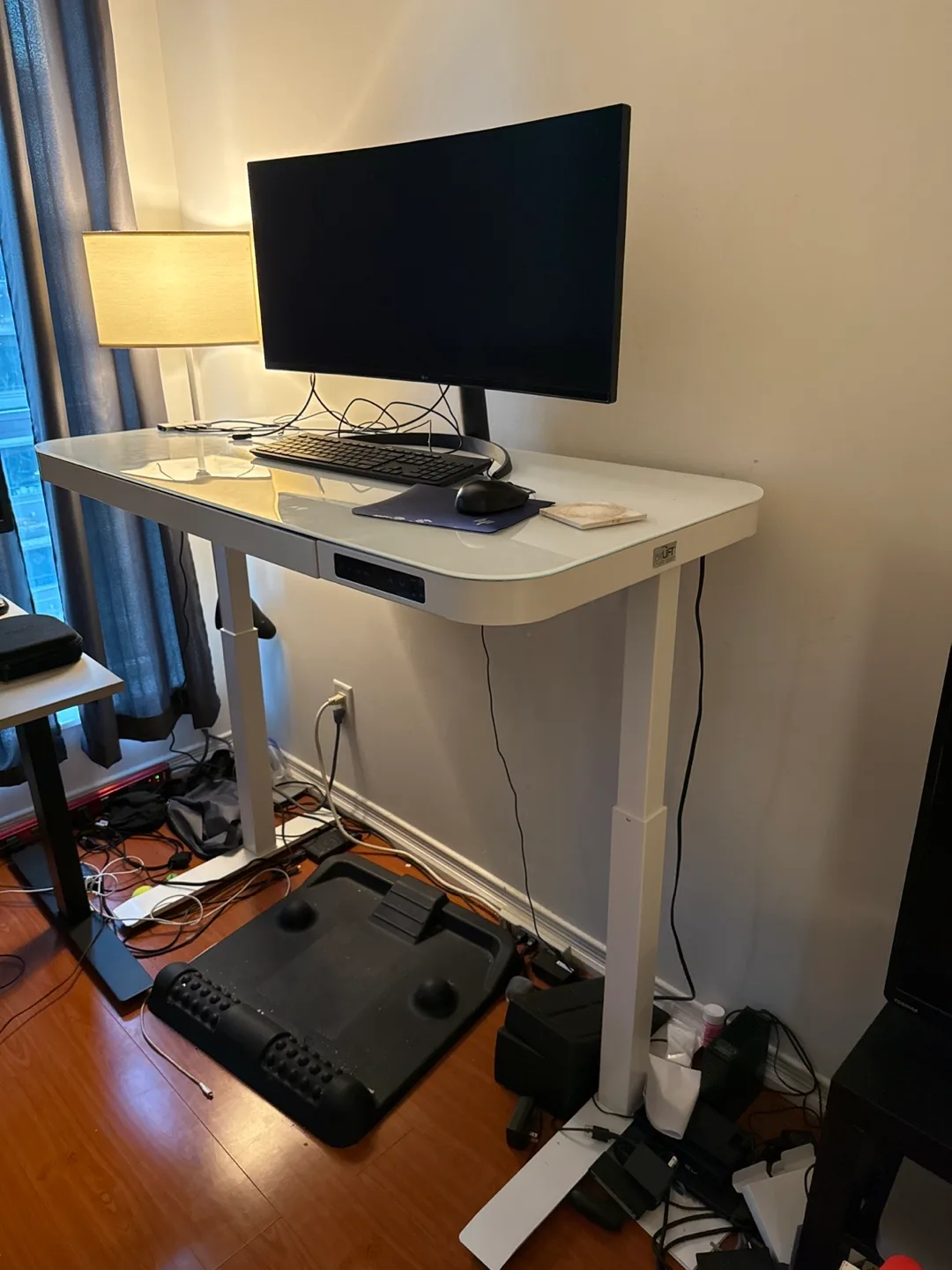 Motion wise electric stand desk with glass top thumbnail