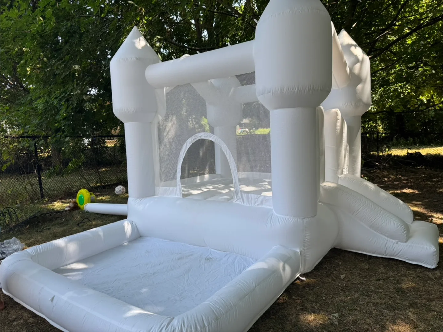 White Inflatable Bounce House with Slide for rent thumbnail