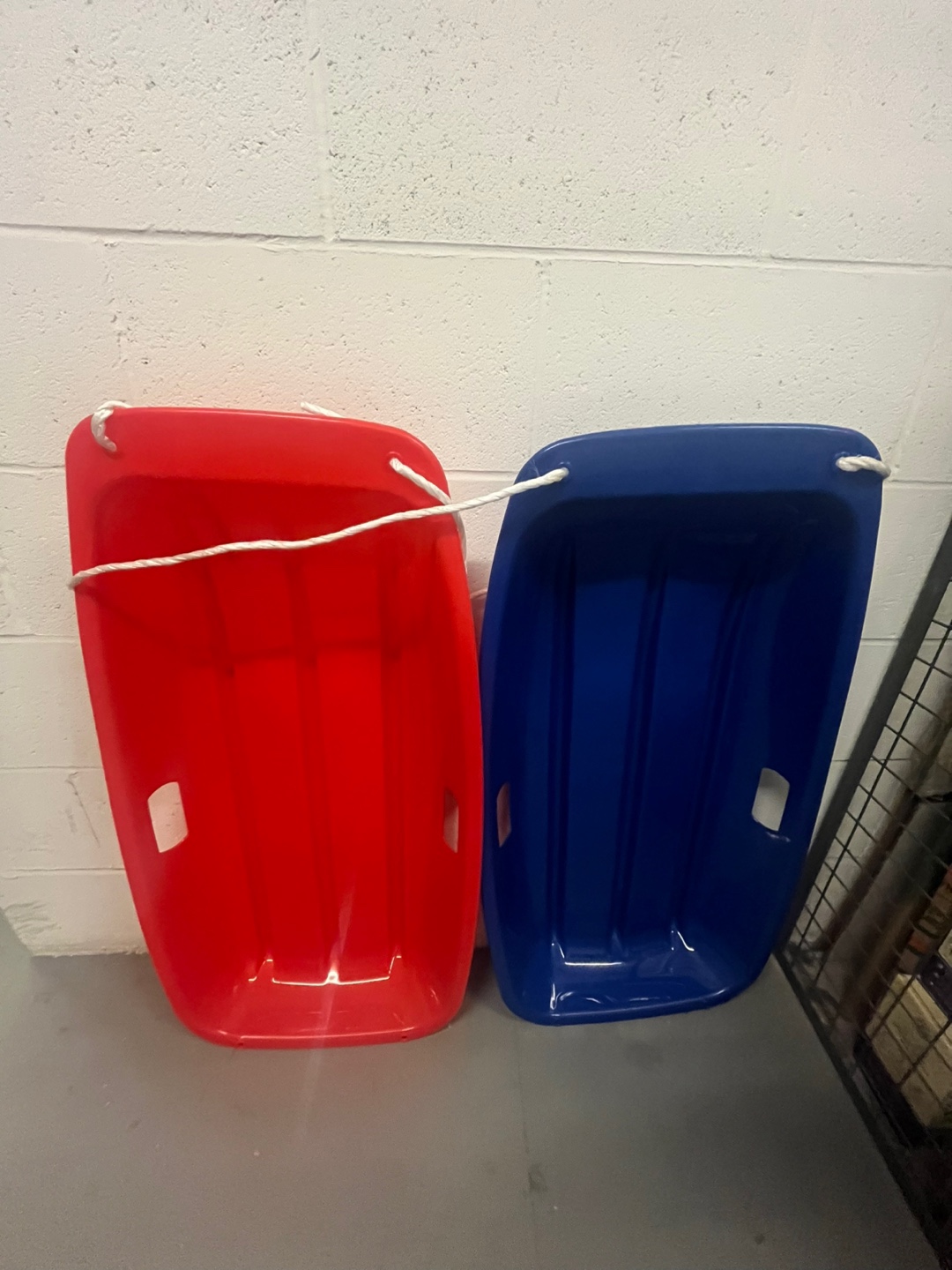 Red and Blue Plastic Sleds