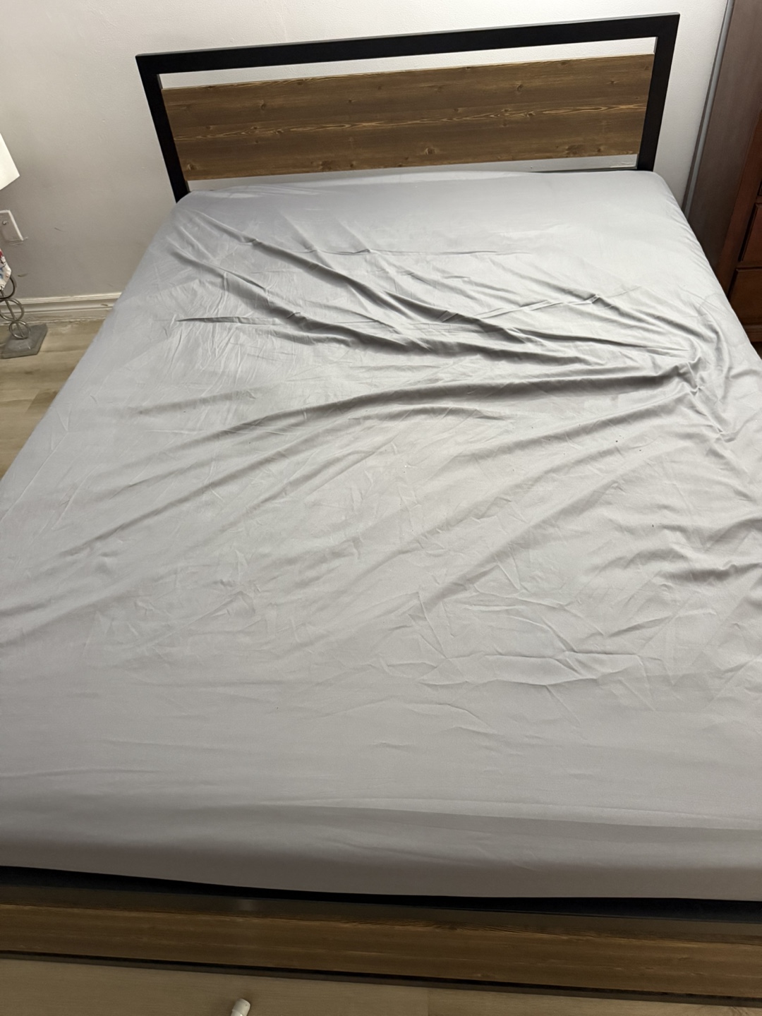 Bed frame with wooden headboard and mattress