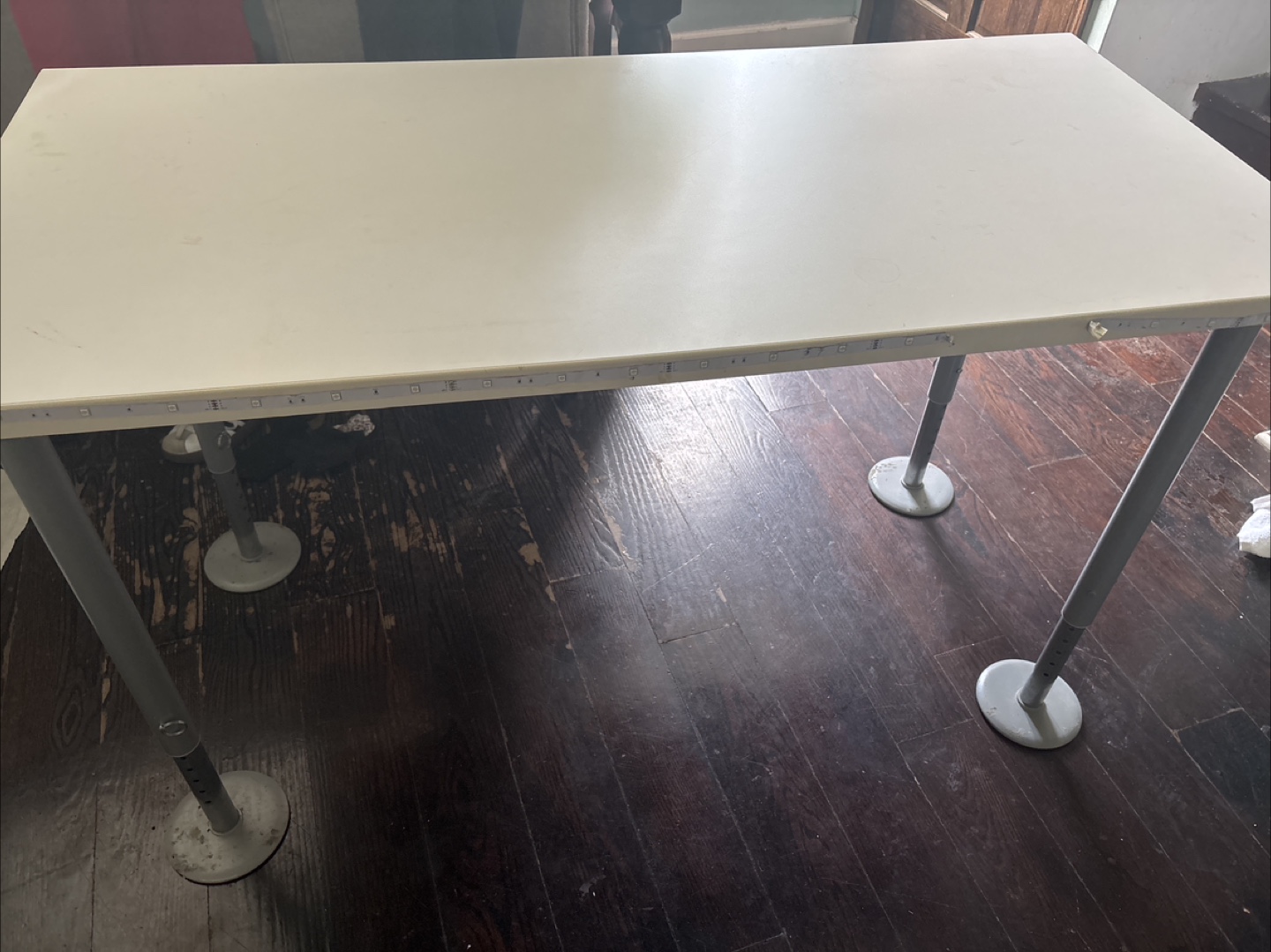 Desk or work table with adjustable legs
