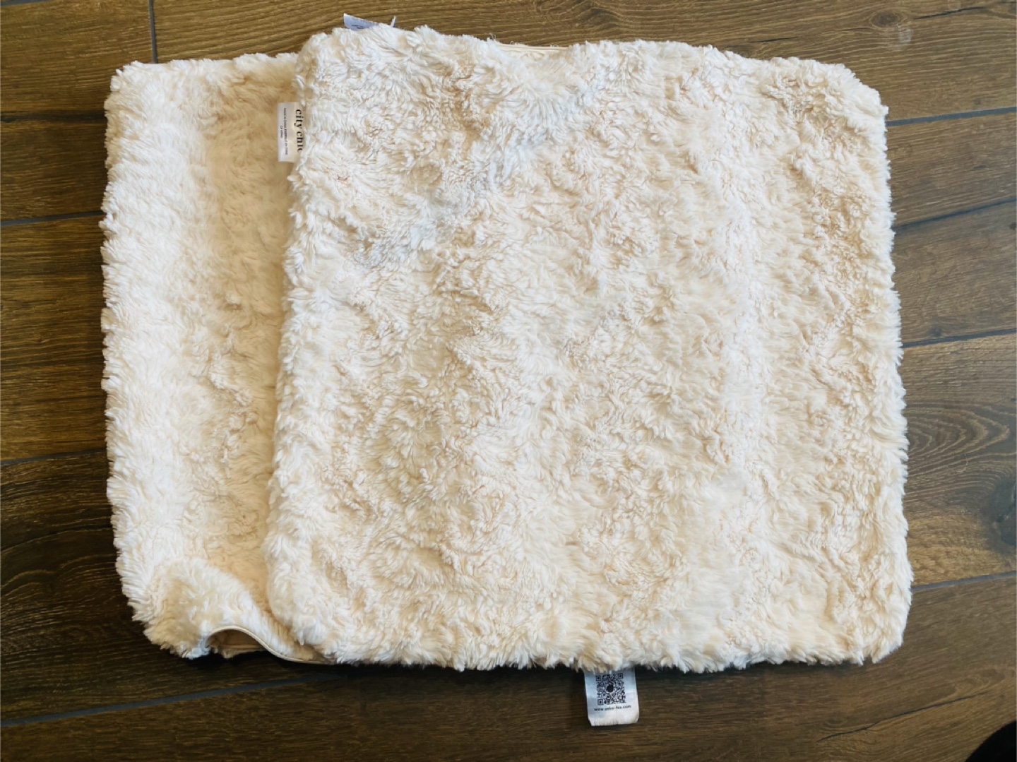 2 fluffy white cushion covers