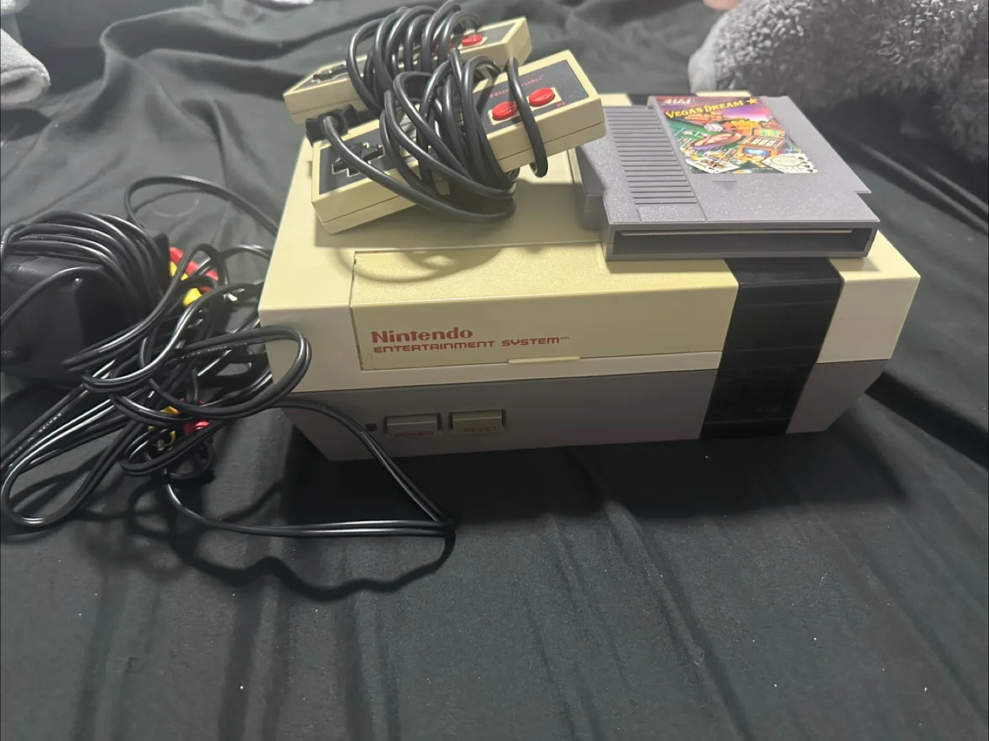 NES console with two controllers and a game